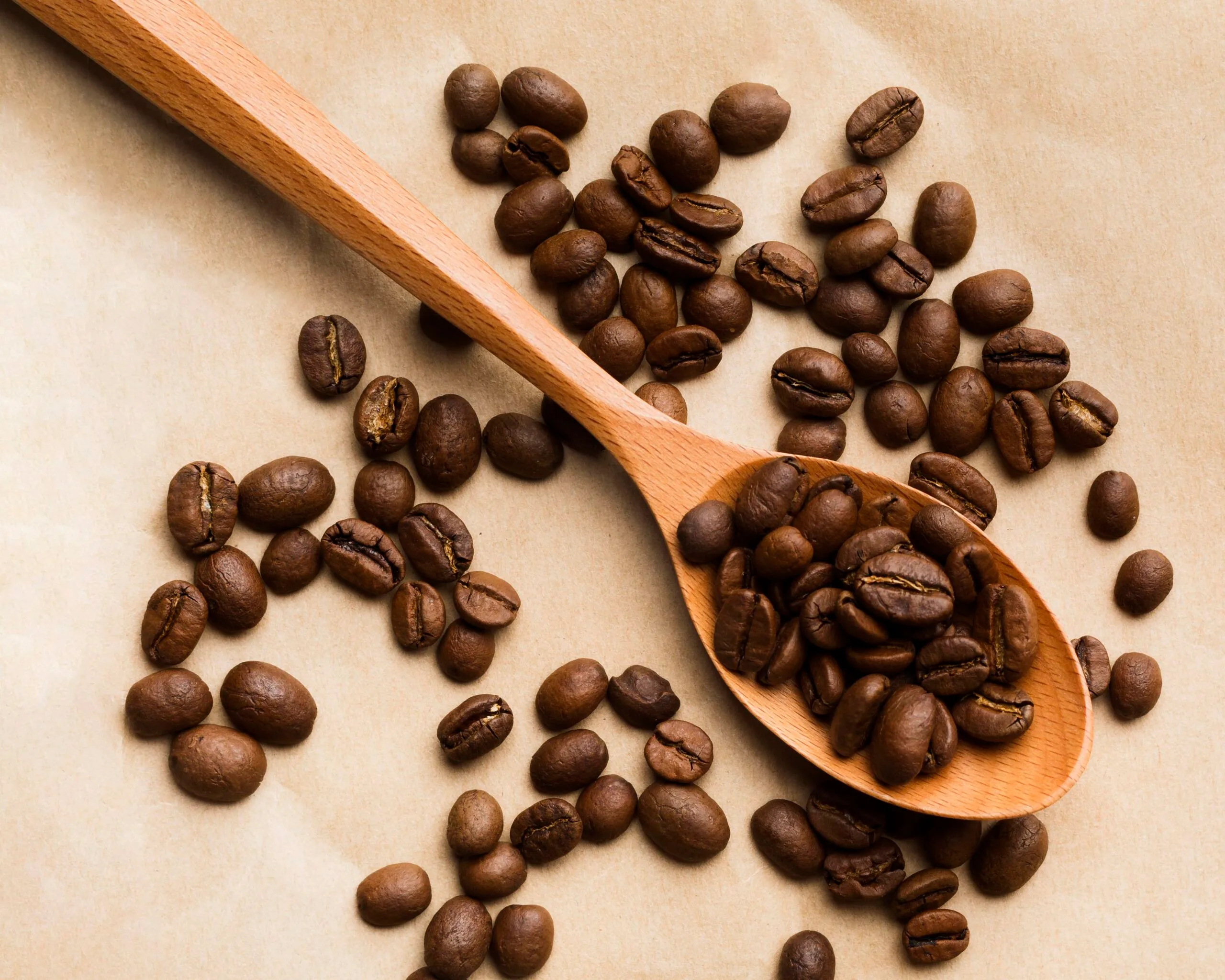 top-view-black-coffee-beans-assortment-paper-background-scaled